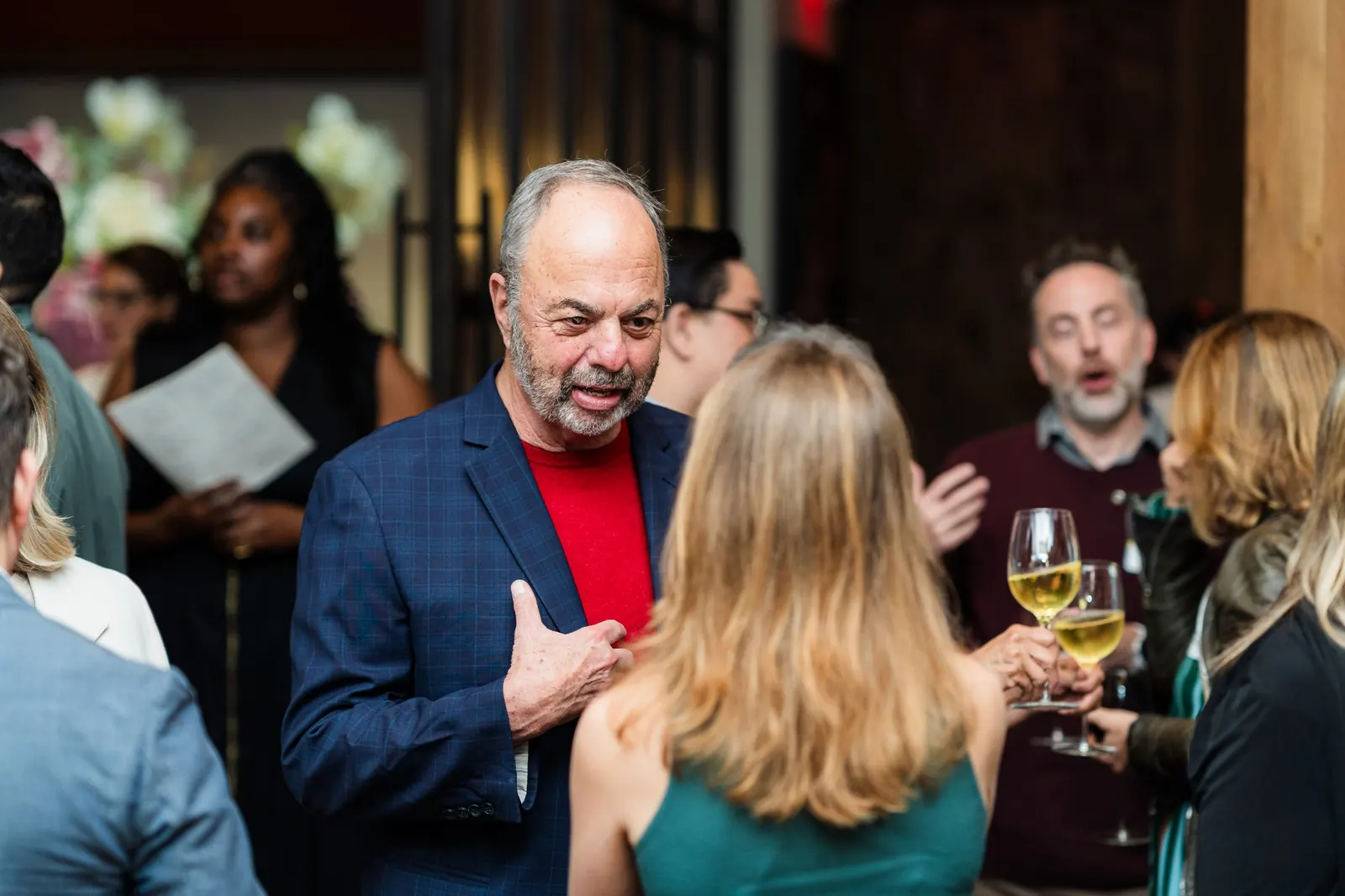 Two campers in animated conversation over wine